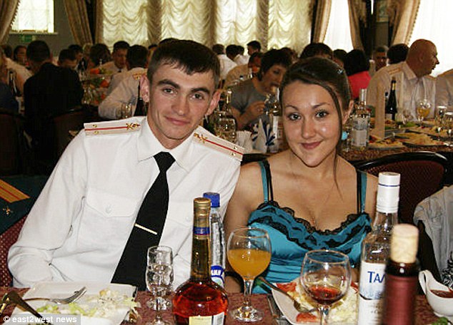 Heroic: Alexander Prokhorenko (left, with his wife Ekaterina) was surrounded by ISIS fighters near the ancient Syrian city of Palmyra when he ordered an airstrike on himself