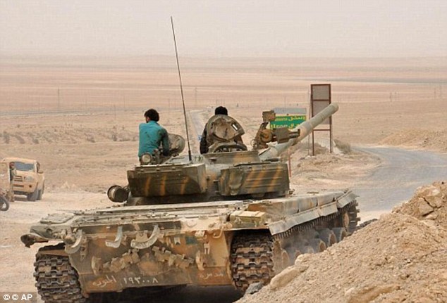 Attack: A Kremlin spokesman Dmitry Russian officers were participating in the advance on Palmyra, claiming the advance was carried out by the Syrian army (pictured, Syrian soldiers near Palmyra)